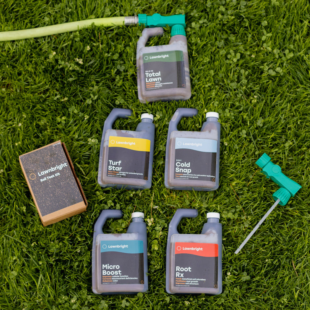 Lawnbright products attached to a hose lying on the grass.