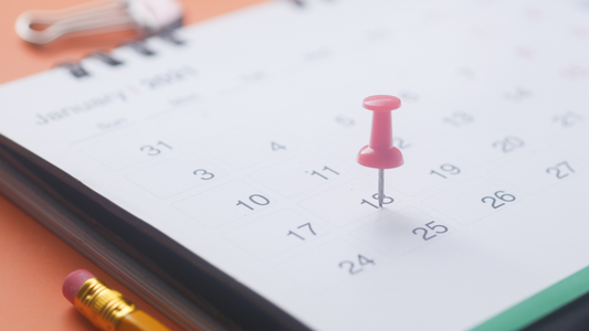 A calendar with a pushpin in it.